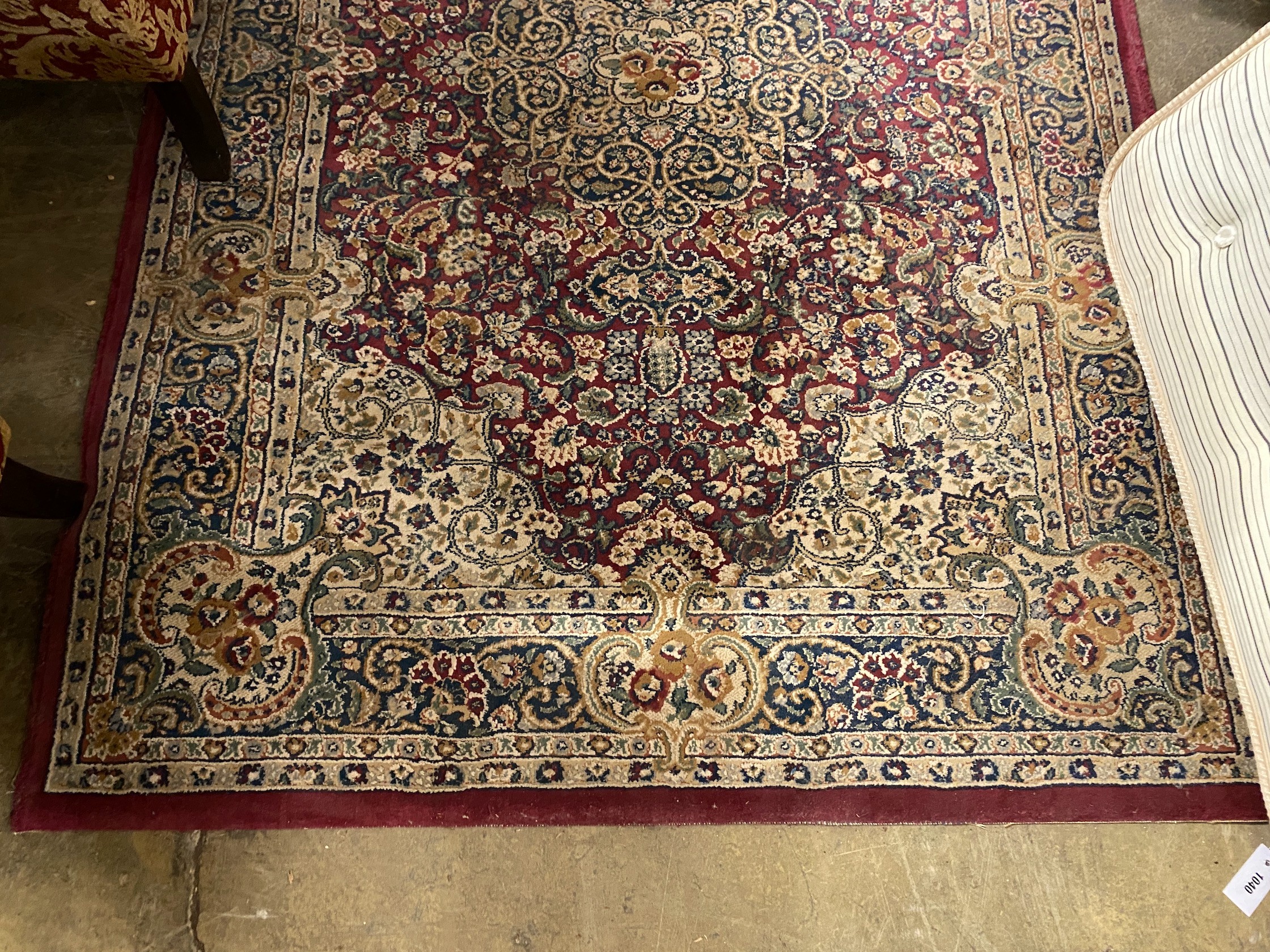 A Persian style burgundy ground machined rug, 196 x 137cm